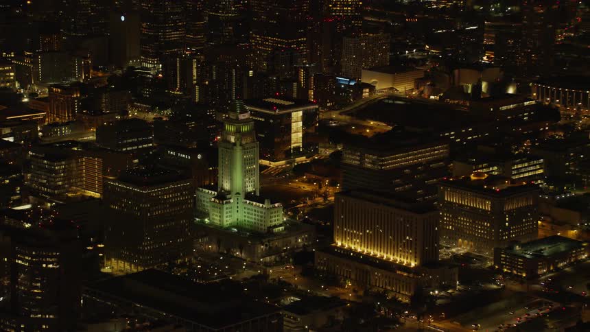 City buildings illuminate the night sky;