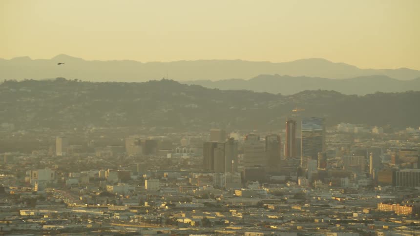 A helicopter flies above the city