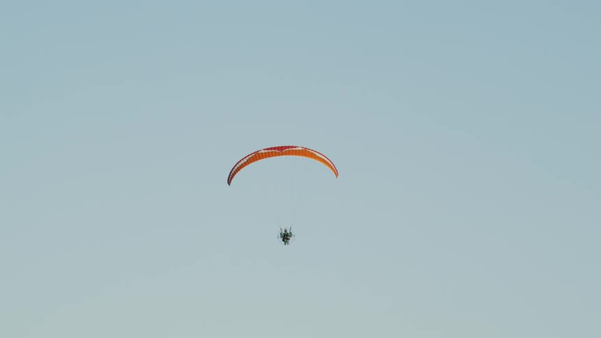 A person parachutes down from the sky