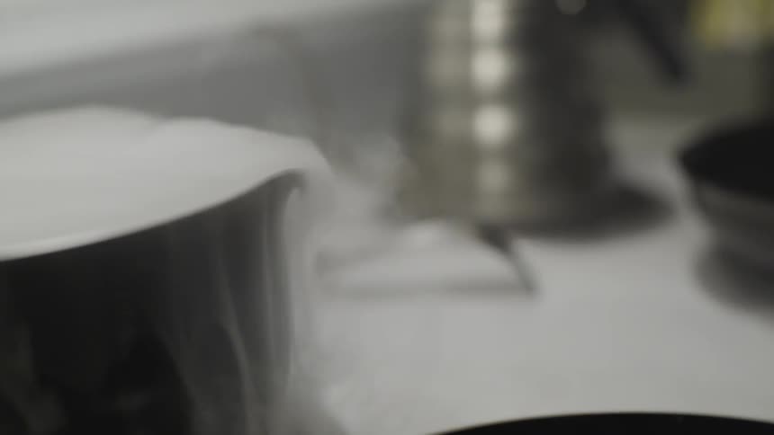 Smoke boils over a metal pot
