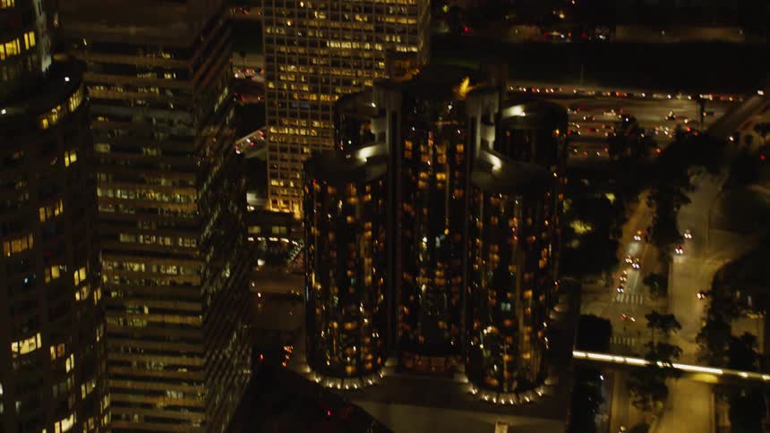 The vehicles turn and move around in the city below
