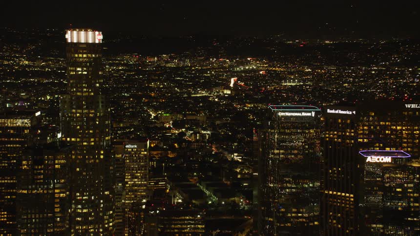 The buildings have many lit windows at night