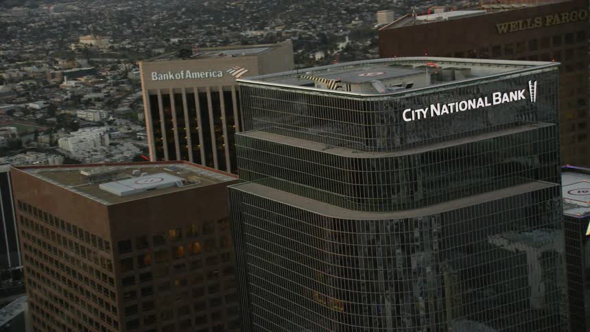 A glass bank building towers into the skyline