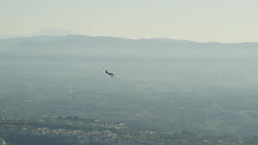 Airplane flies lower over a small town