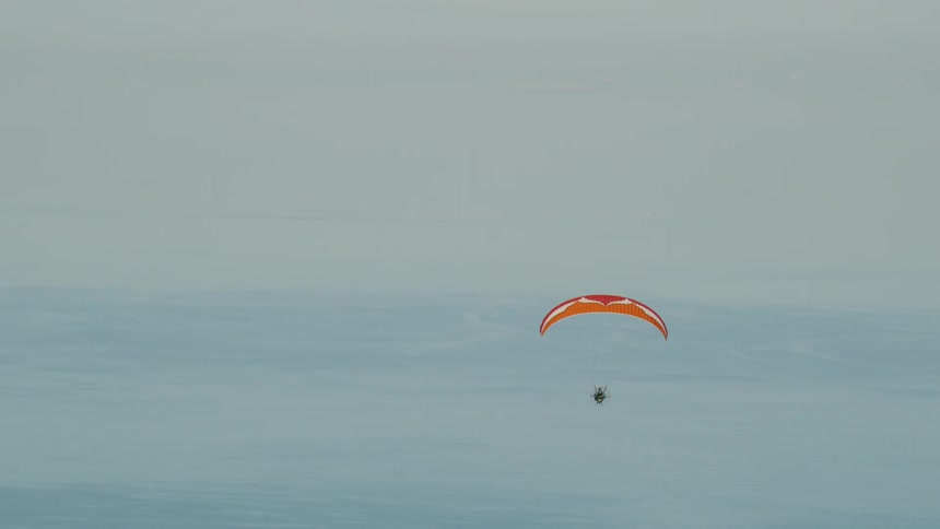 A man parachutes down from the sky