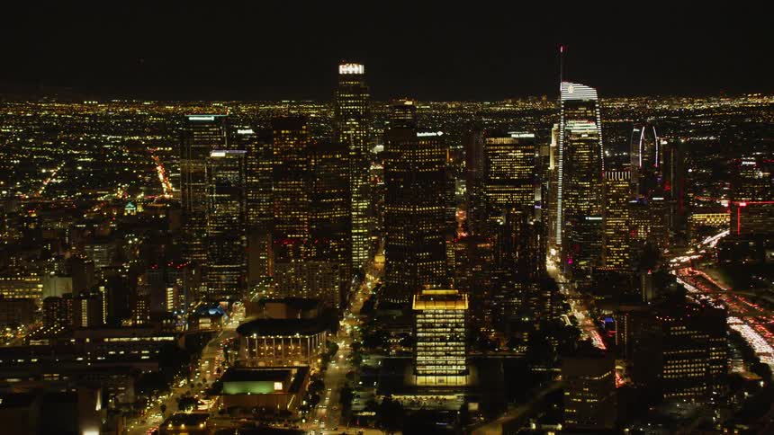 Skyscrapers stand in a city at night; Los Angeles