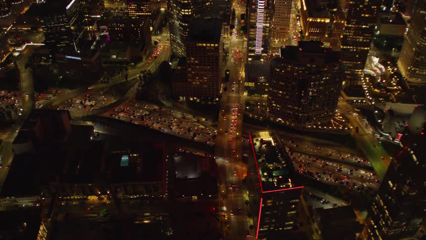 Vehicles travel on city roads at night