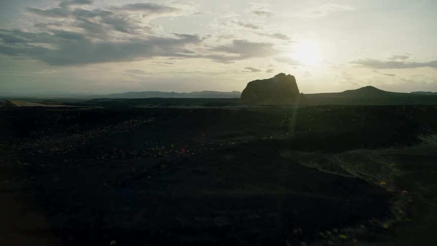 Sun shines over muddy hilly land
