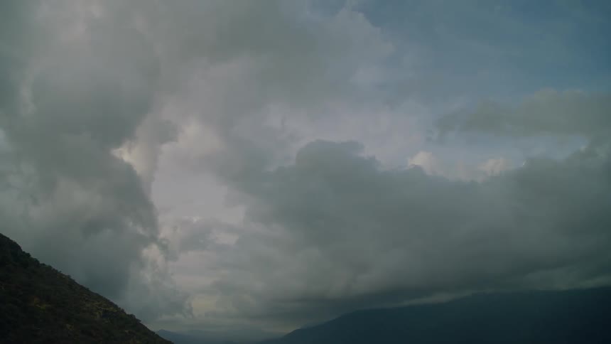 Clouds float above mountains