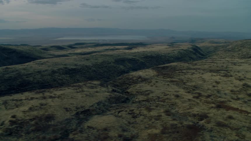 A rural landscape is shown at sunset