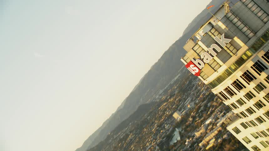 Sun shines down on a large city with tall skyscrapers