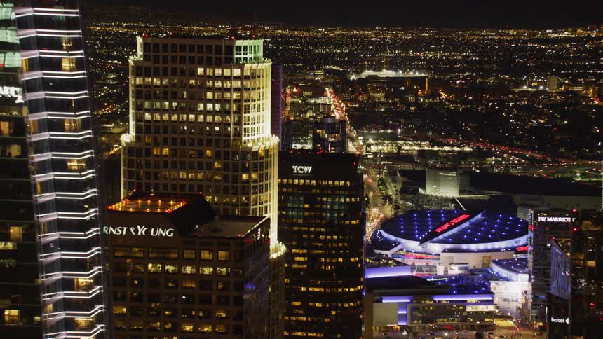 Tall city buildings illuminate the night sky; Los Angeles Skyline