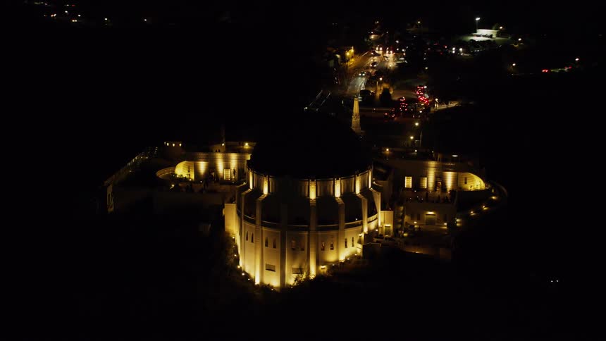 The stone building is brightly lit at night