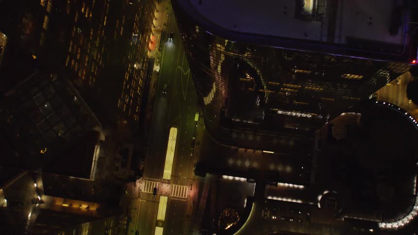 Illuminated buildings sit under a dark sky at night