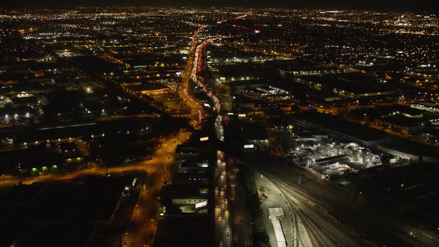 The cars move slow in the traffic at night