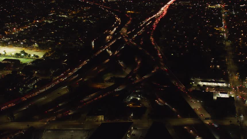 Vehicles travel on city roads at night