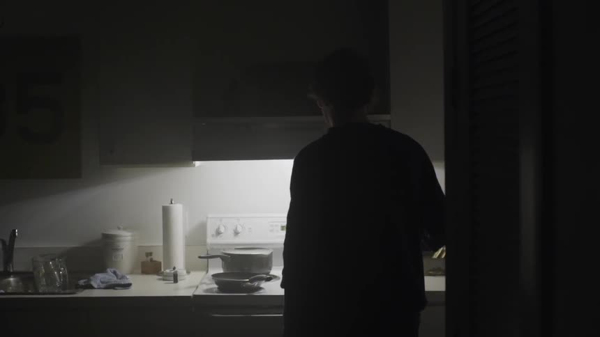 A man is cooking for himself, alone