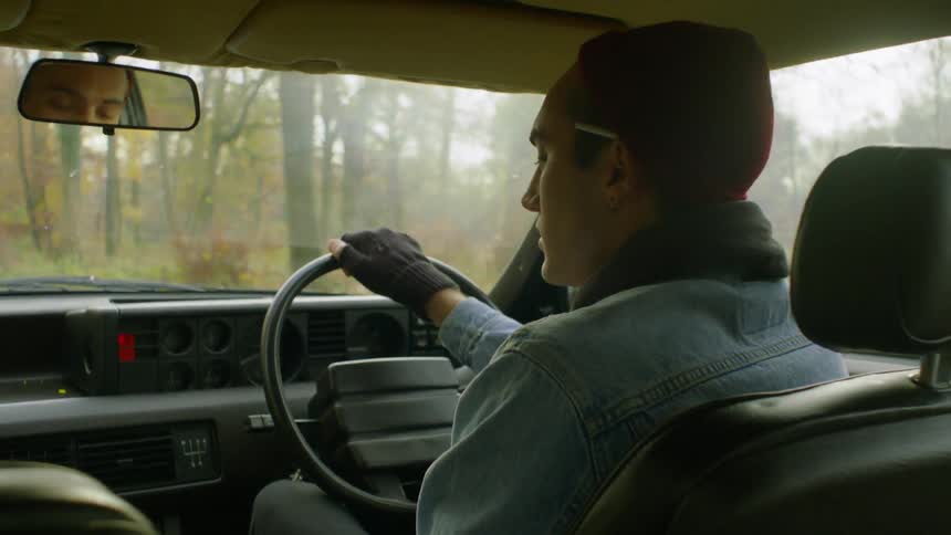 Man drives a vehicle through the woods on a sunny day