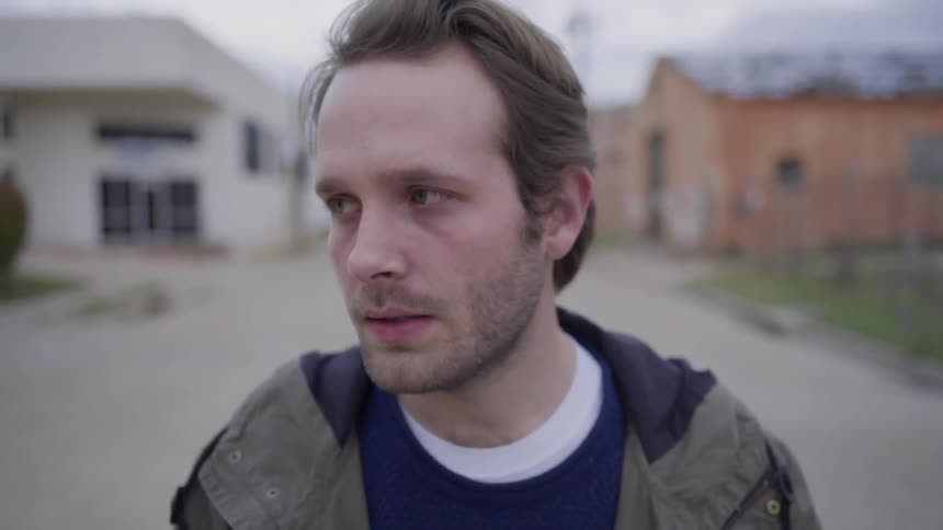 A man is smoking in the street