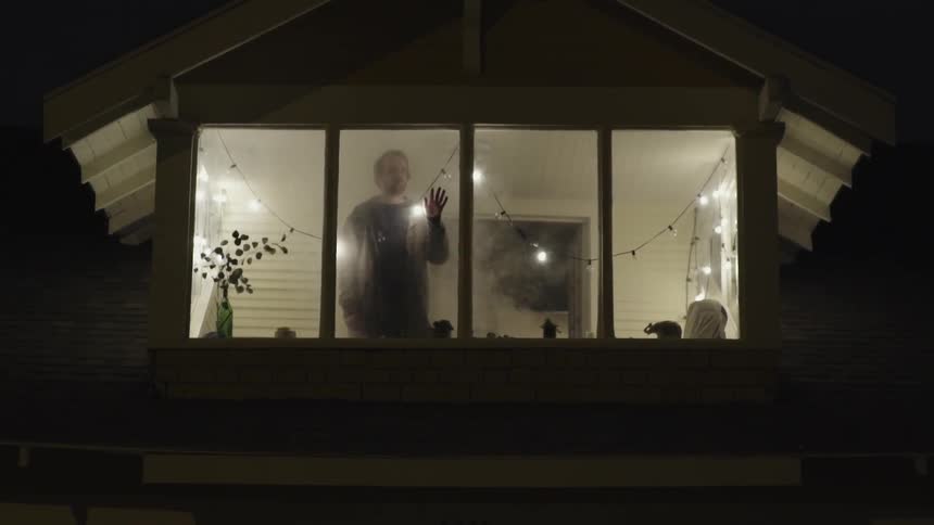 A man watches out his window