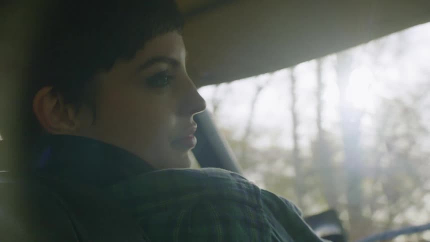 A woman talks while riding in a vehicle