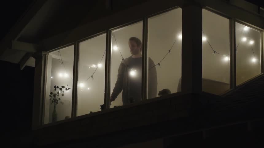 A man is staring out his window