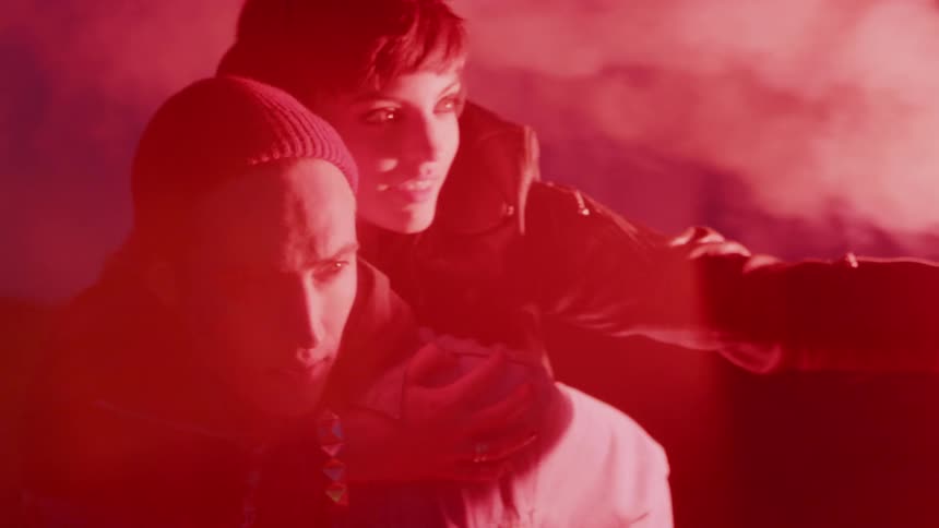 A woman is piggybacking on a man's shoulders