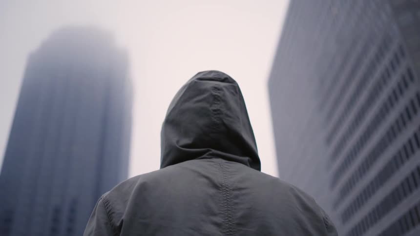 A man stares up at buildings