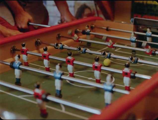 People play a game of table soccer