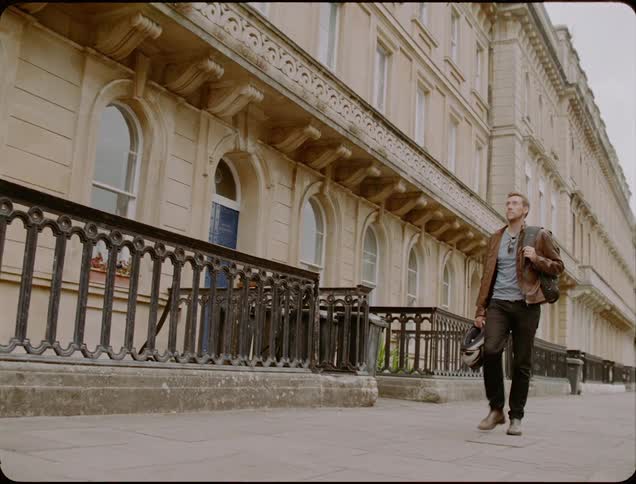 A man walks by a city building