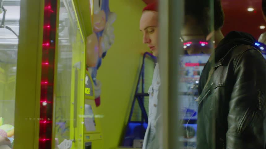 Man and woman play games in an arcade