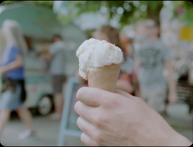 A person takes a lick from the ice cream cone