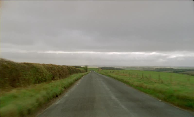 Grassy farmland on a cloudy day
