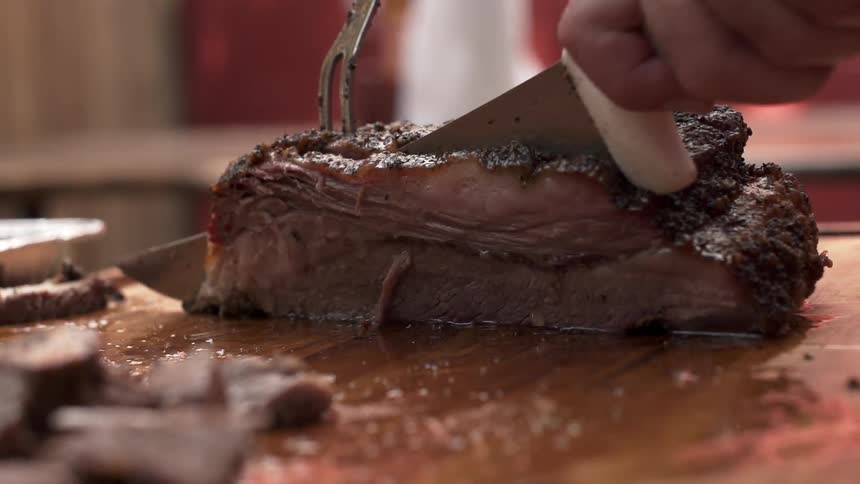 A person sliced grilled beef