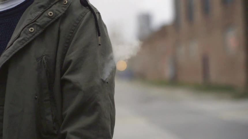 Hole in a person's jacket that is giving off smoke