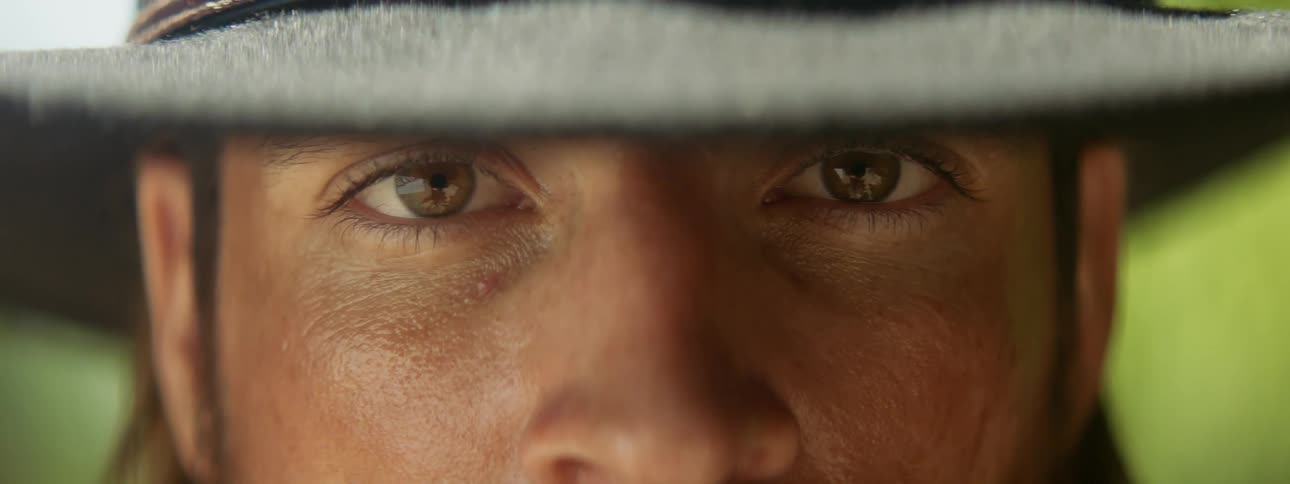 A man squints his eyes as he looks forward