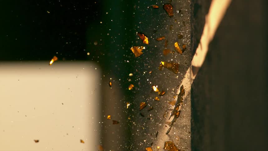 A bottle is crashed against the wall