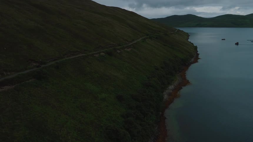 A truck drives on the side of a mountain