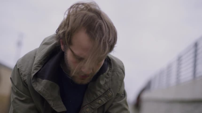 A man is looking at the ground