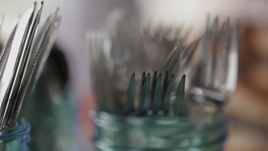 Silverware is organized into glass cups