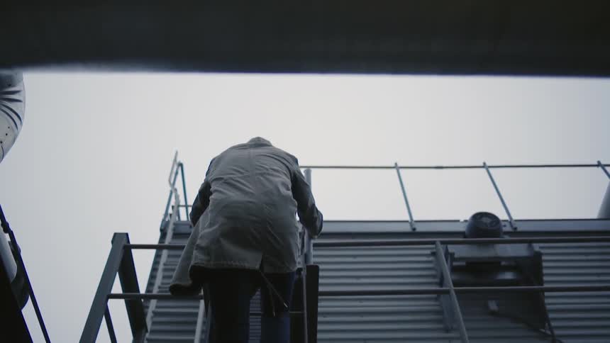 A man is climbing a ladder