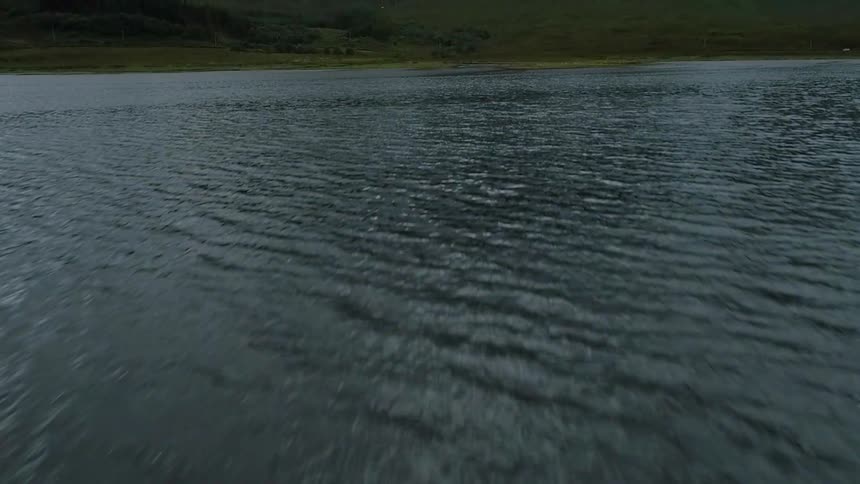 The water large rocks touching the surface in spots