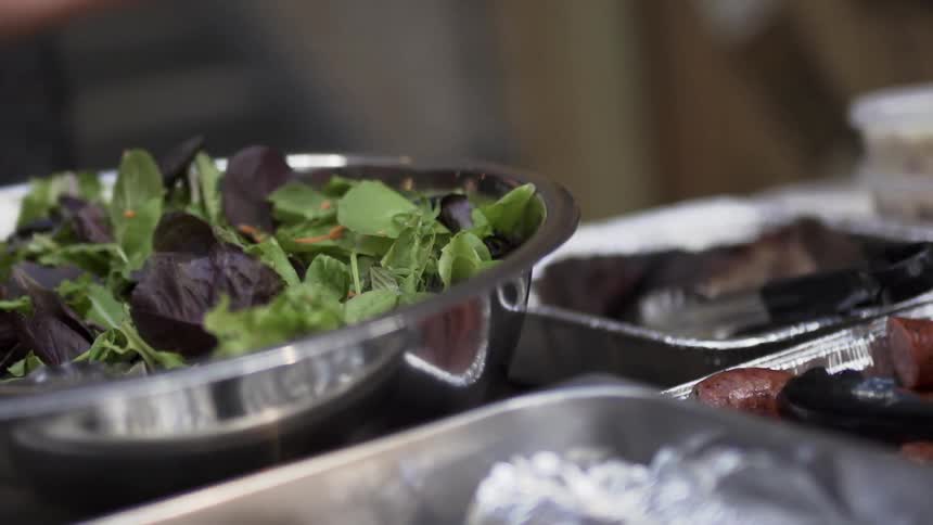 Salad is served in a large bowl at a cookout