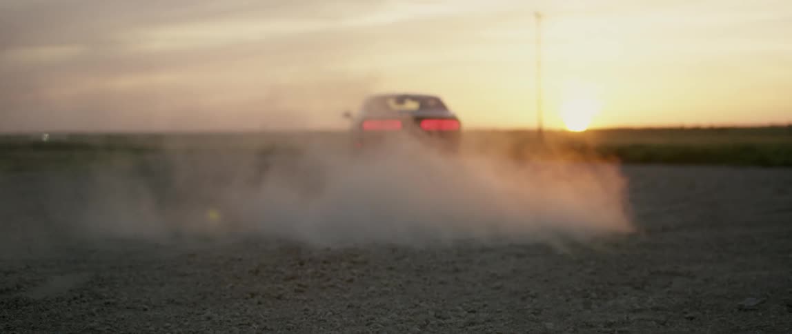 A dodge charger peels off at a high speed