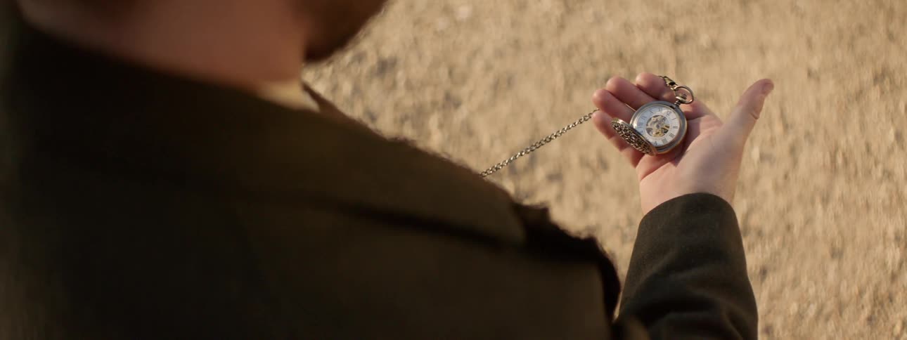 A man checks his pocket watch