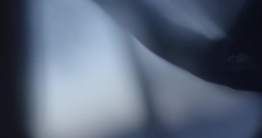 A black curtain hangs in front of a window