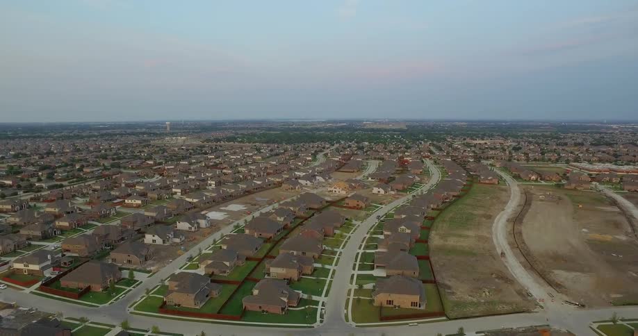 Rows of houses sit under a blue sky