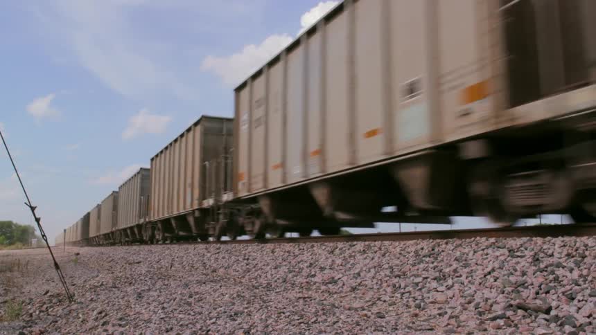 The train cars move past the tracks quickly