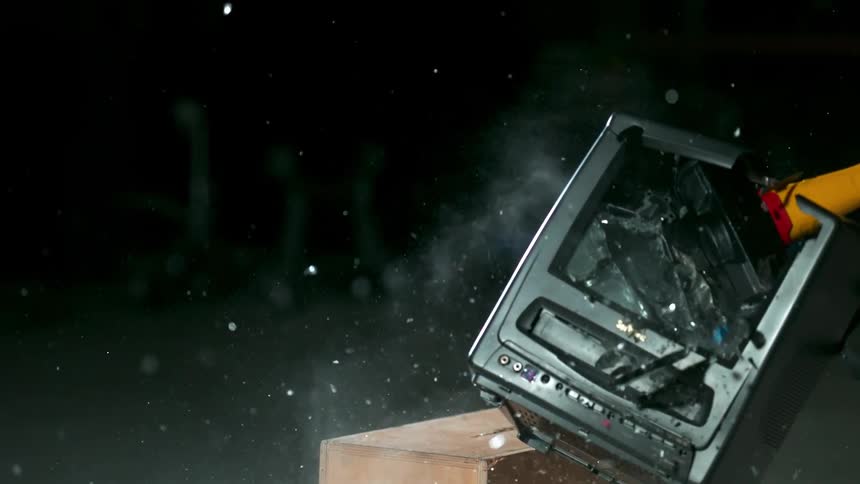 A television is slammed with a sledge hammer