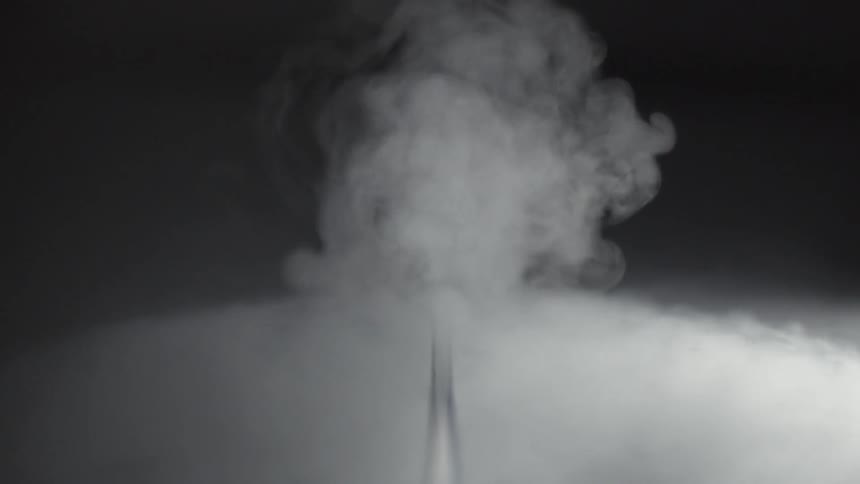 Smoke fills the dark room